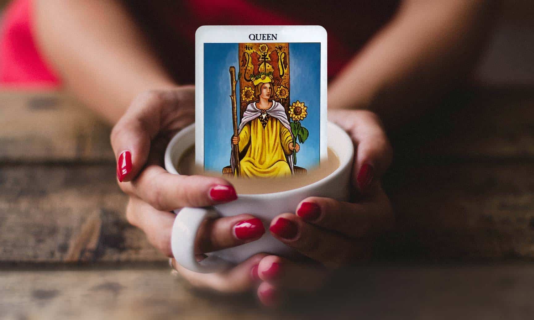 Hands holding coffee cup with tarot card
